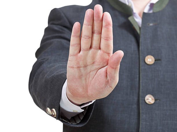 istock stop sign by one palm - businessman hand gesture 505839143