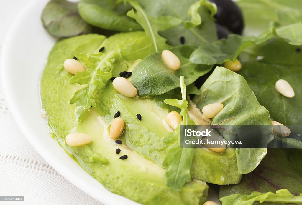 Salad with avocado and arugula Green salad with avocado and pine nuts Appetizer Stock Photo