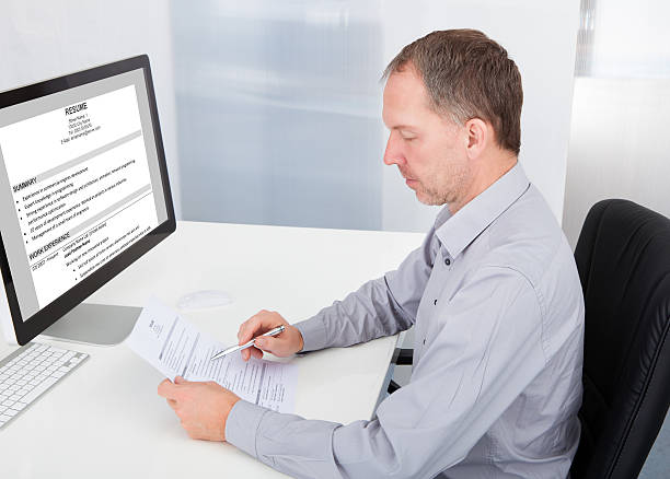 istock Businessman Reading Resume 505842843