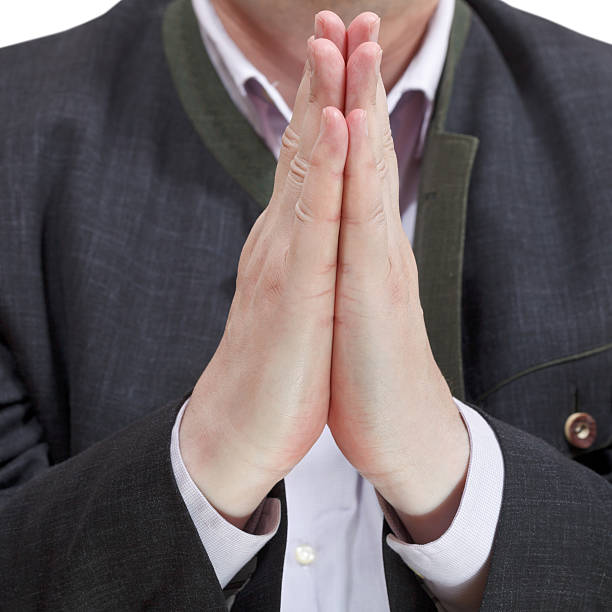 istock front view of male praying hands - hand gesture 505843373