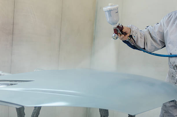 istock Worker painting a car 505843693