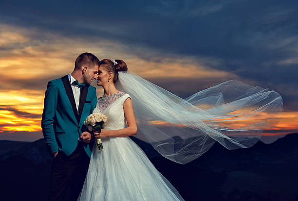 romantic moments for us bride and groom feeling affectionate, loving and posing at sunset.veil flying. veil photos stock pictures, royalty-free photos & images