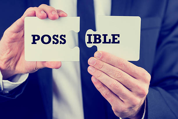 istock Man holding puzzle pieces with the word Possible 505844701