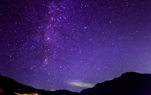 purple night sky stars. Milky way across mountains