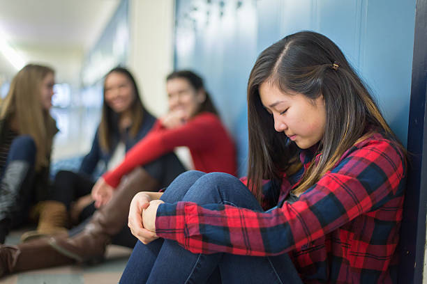 istock Girl getting bullied in high school hallway 505845246