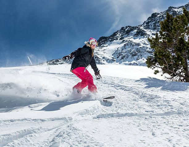 istock Woman snowboarder in motion in mountains 505845962
