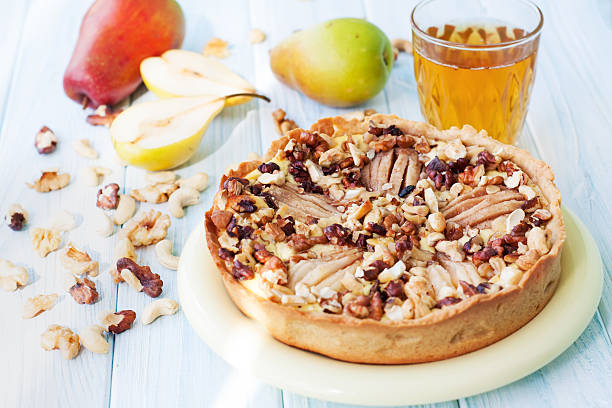 istock Nuts pear tart on wooden table 505848292