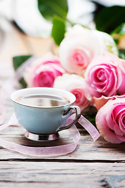 istock Pink roses and coffe on the wooden table 505849584