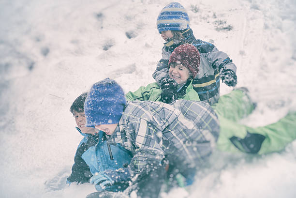 istock Four children sledding in a snow storm 505850676