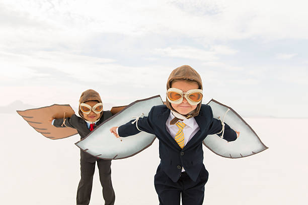young business jungen trägt pappe wings - taking off business creativity adventure stock-fotos und bilder