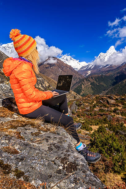 istock Young woman using laptop in Himalayas, Nepal 505851328
