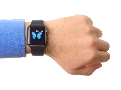 İstanbul, Turkey - December 2, 2015: Man hand wearing an Apple Watch on a white background. Apple Watch is a smart watch developed by Apple Inc.