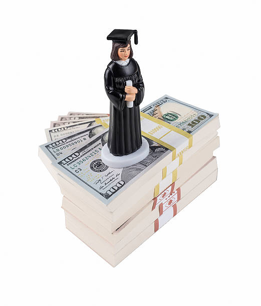 Graduate Figurine Stands Atop Stairway to Wealth and Prosperity stock photo
