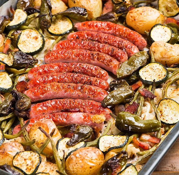 istock Sausages with vegetables on a grill pan 505865264