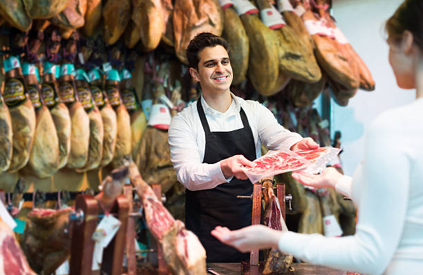 istock brunette choosing iberico and serrano jamon and smiling 505866184