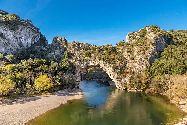 The natural landmark Pont dÂ´Arc at the Gorges de l'Ardeche in Vallon (France). A famous sightseeing and sports destination for kayaking and swimming.