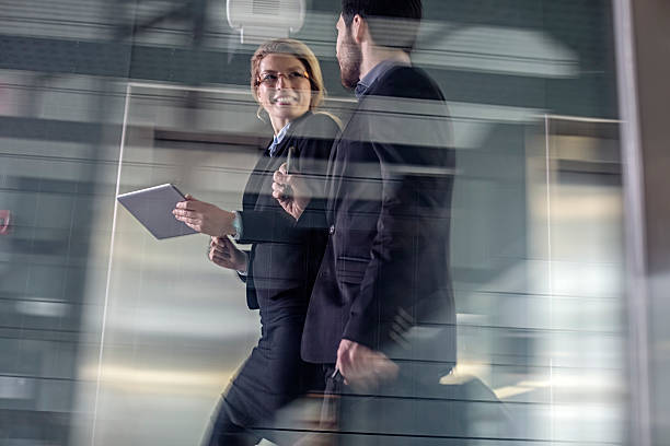 istock Two Business coworkers walking along elevated walkway 505869704