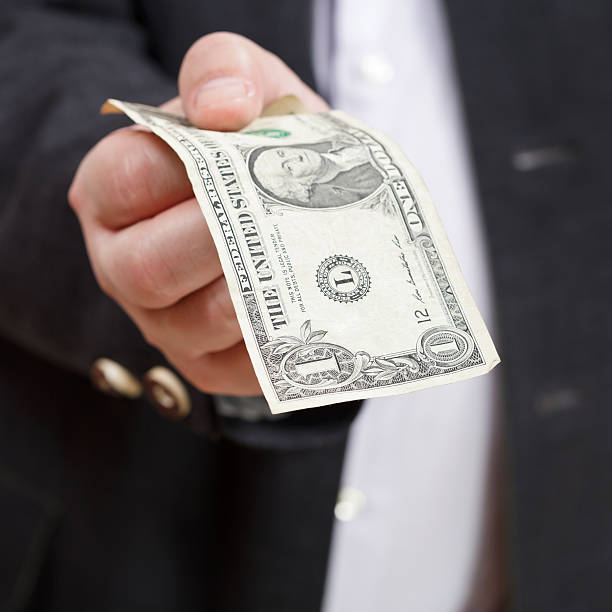 istock front view of one dollar banknote in male hand 505870331