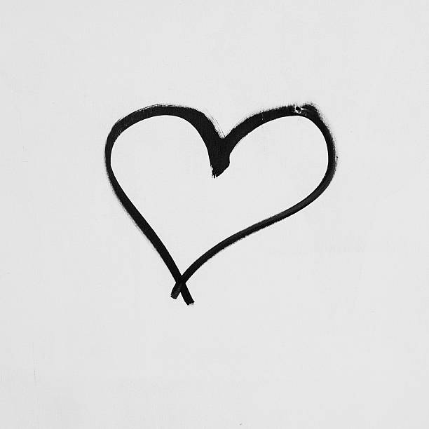 Heart shape sketched on a white wall in black ink