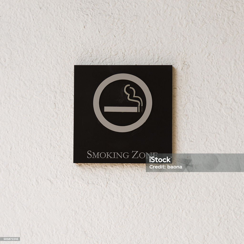Smoking zone Smoking zone sign on the wall. Addiction Stock Photo