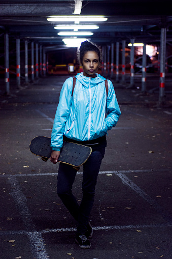 Young girl holding skateboard