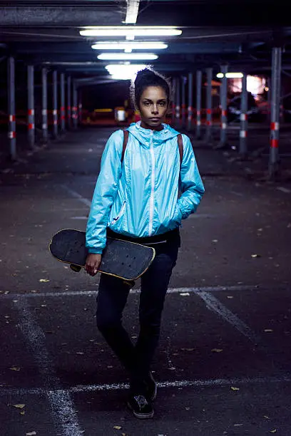 Photo of Portrait of girl holding skateboard