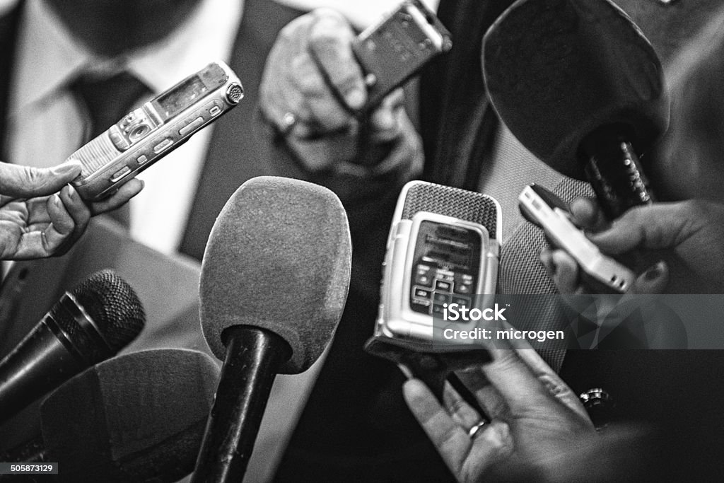 Old news Journalists with recording equipment flocking around important people. Black and white retro style processing Journalist Stock Photo