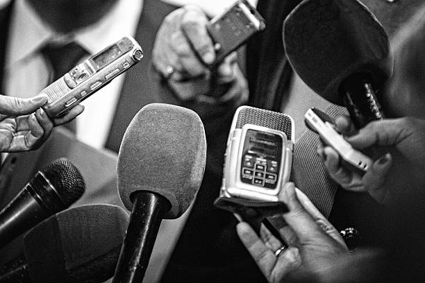 Old news Journalists with recording equipment flocking around important people. Black and white retro style processing spokesperson stock pictures, royalty-free photos & images