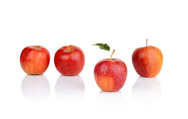 Photo of Apple which stands out from the crowd isolated