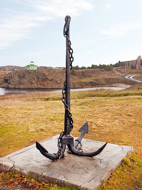 istock Large sea anchor on the shore 505873303