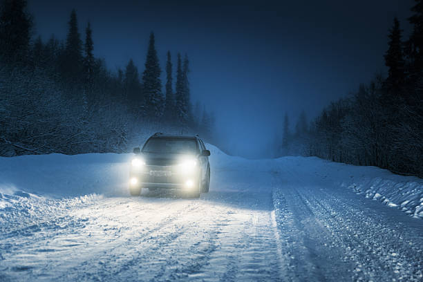 istock Car lights in winter Russian forest 505873421