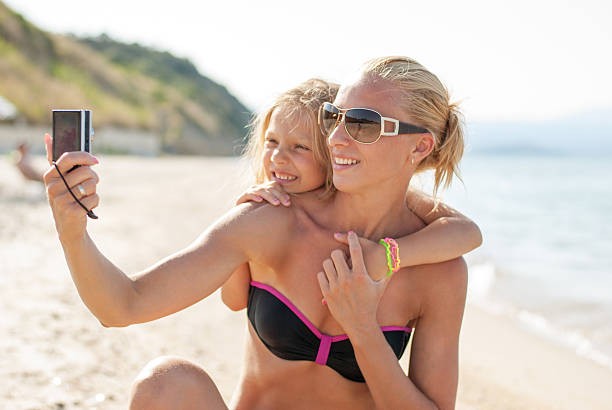 istock Mother and daughter at the beach 505873457