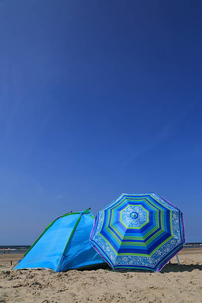 istock Summer on the beach - blue parasol 505873973