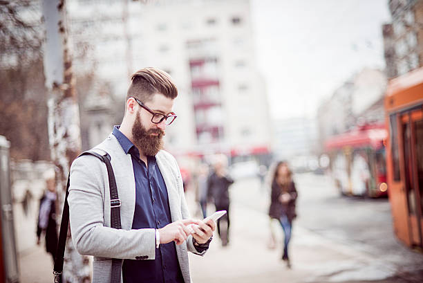 istock stylish businessman using his smartphone 505875836