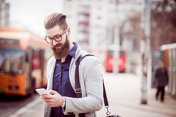 istock stylish man using his smartphone in the city 505875946