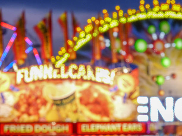 All the colors of a rainbow against a night sky -- the spokes of the ferris wheel and sundry other thrill rides and more