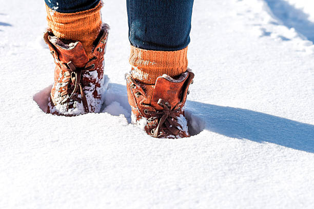 nur wenige schritte auf die verschneiten road - snow track human foot steps stock-fotos und bilder