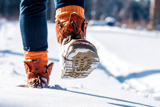 nur wenige schritte auf die verschneiten road - snow track human foot steps stock-fotos und bilder