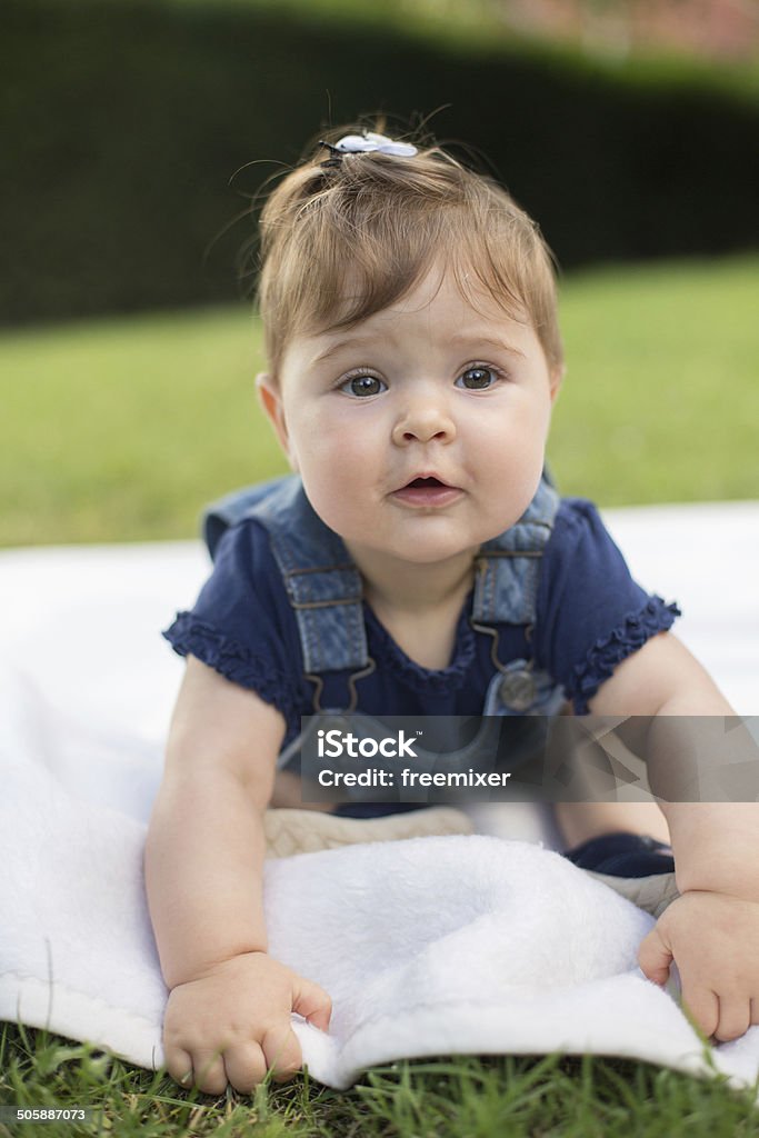 Funny baby Baby laying on the green grass Baby - Human Age Stock Photo