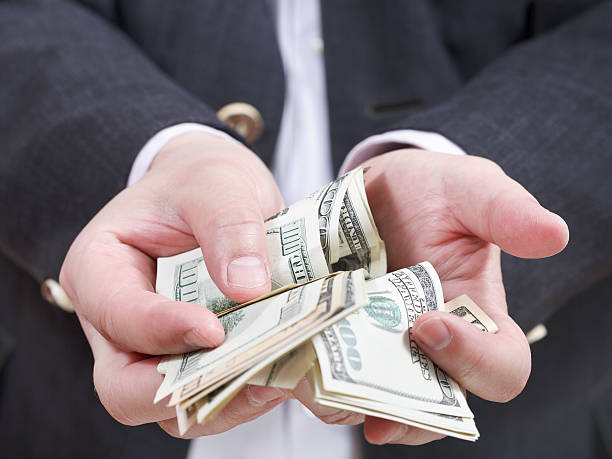 istock front view of many dollar banknotes in male hands 505887091