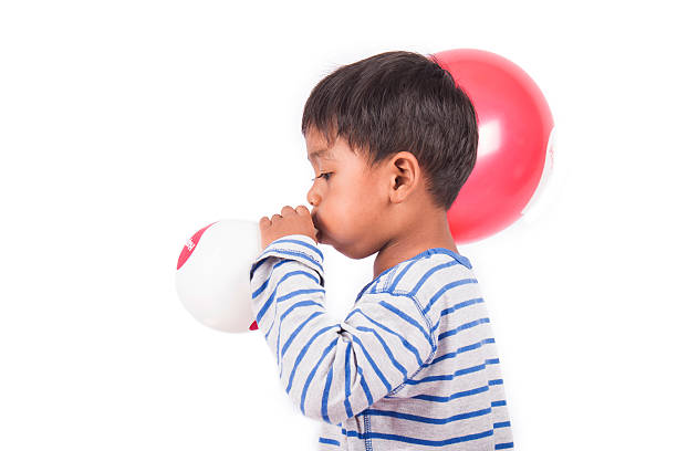 istock little boy blow up balloon 505889706