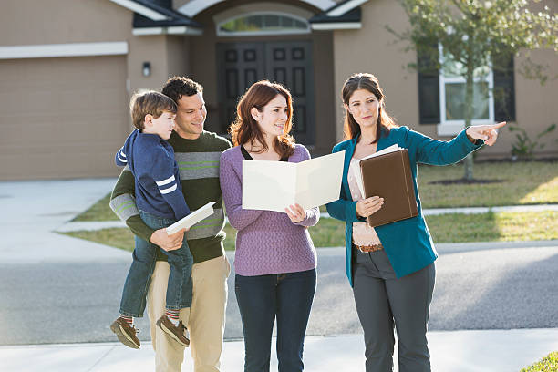 familia con agente inmobiliario asamblea caza - moving house physical activity real estate couple fotografías e imágenes de stock