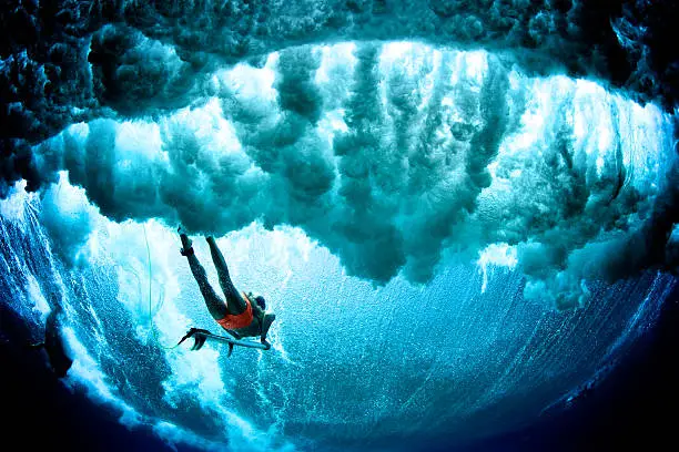 Photo of Dark cloudy duck dive surfer