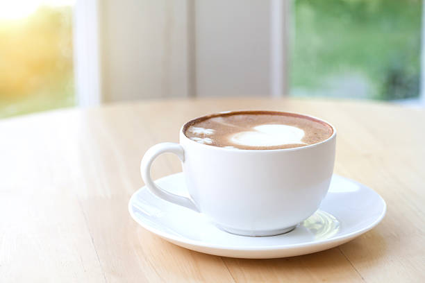 istock heart symbol on latte coffee cup on table 505890102