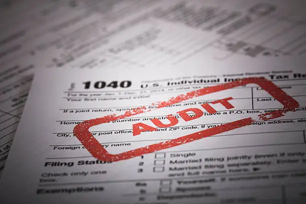 A stock photo of a Red Audit stamp on a 1040 US individual income tax return. Photographed at 50mp with the Canon EOS 5DSR and the 100mm 2.8 L lens.