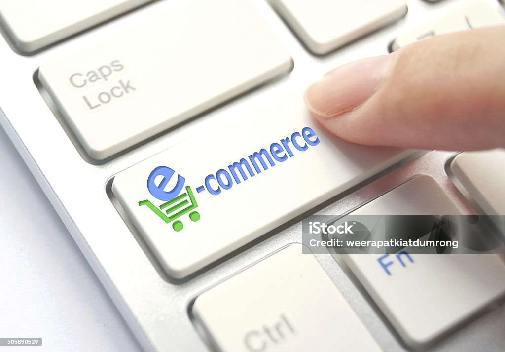 E-Commerce finger pressing E-Commerce Button on Computer Keyboard. Internet Concept. Abstract Stock Photo