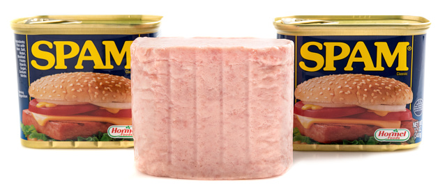 Miami,Florida, USA - May 31, 2015: SPAM Meat and two cans of SPAM isolated on a white background. Spam stands for Spiced Pork and Ham, which is a canned precooked meat product. It is made by the Hormel Foods Corporation and was introduced in 1937.