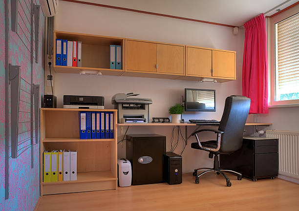 Home office Workspace in a home office. The clothes horse at the left clearly indicates the concept of a home. small office stock pictures, royalty-free photos & images