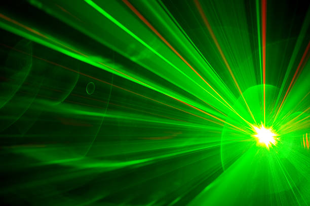Green laser aimed at night sky with stars