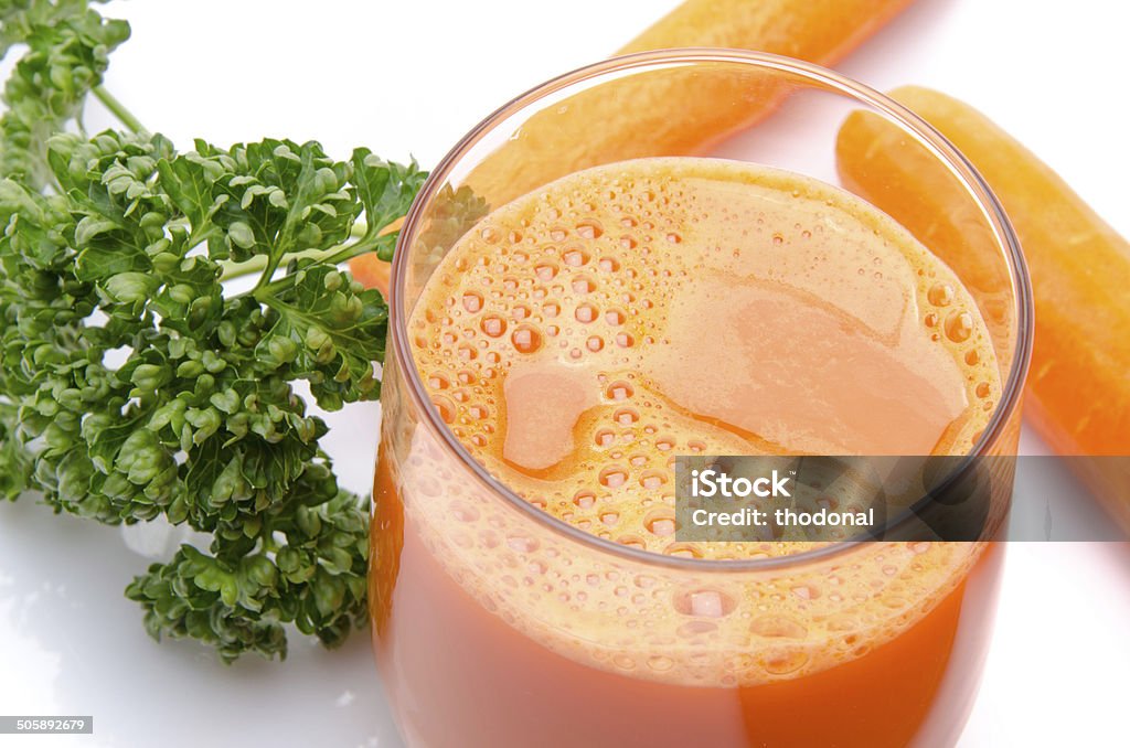 Composition with a glass of carrot juice and fresh carrots Composition with a glass of carrot juice, fresh carrots and parsley, isolated on white Breakfast Stock Photo